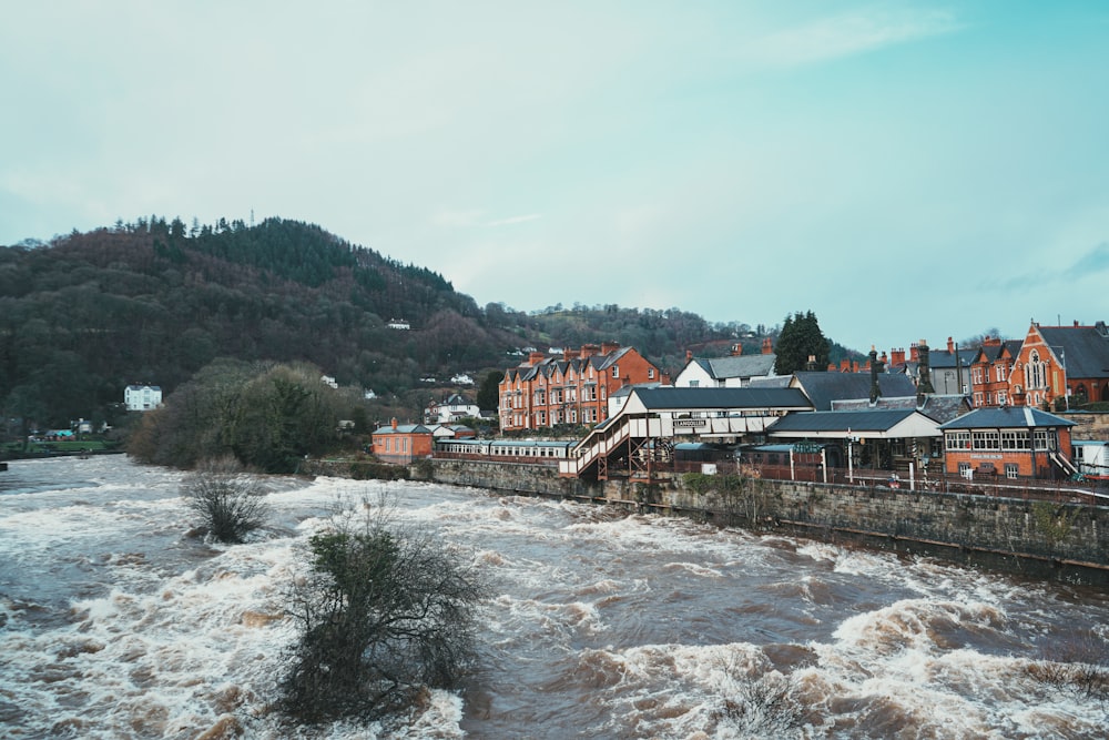 a river running through a town surrounded by mountains