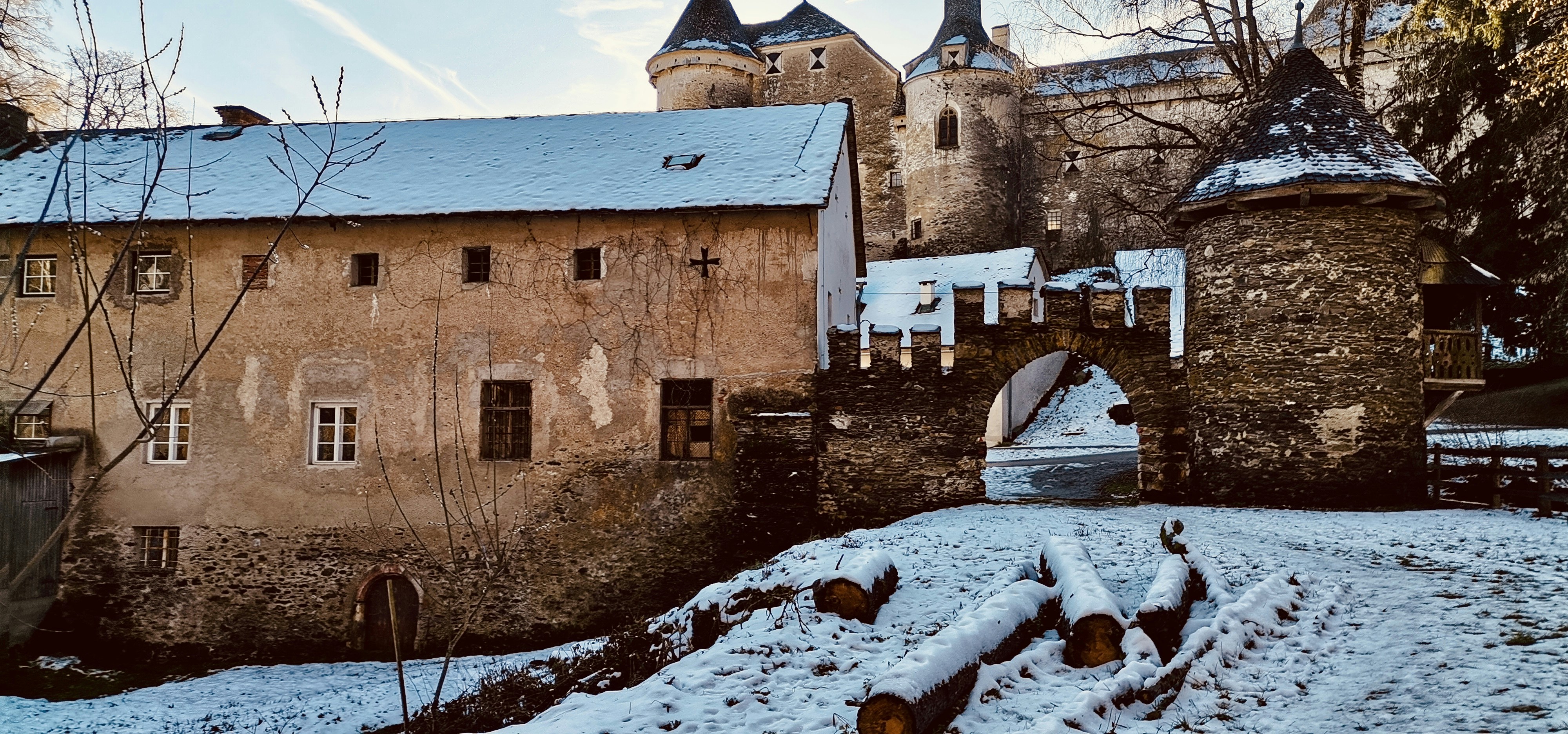 a castle in the snow with a bridge over it, 