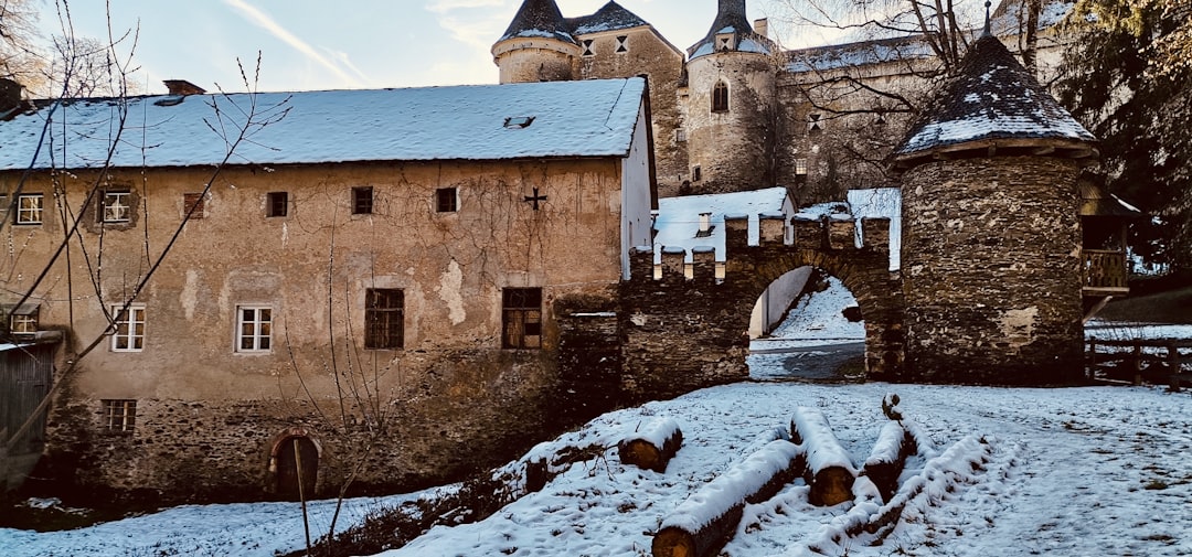 a castle in the snow with a bridge over it,