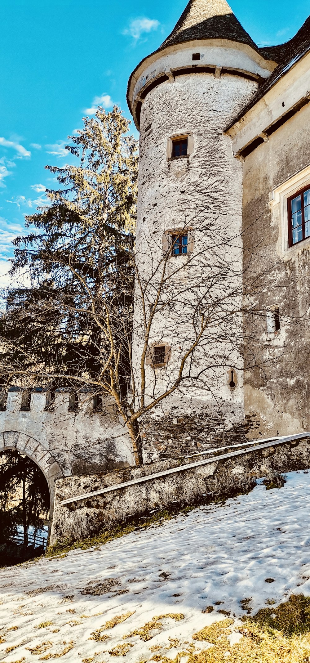 a stone building with a tree in front of it