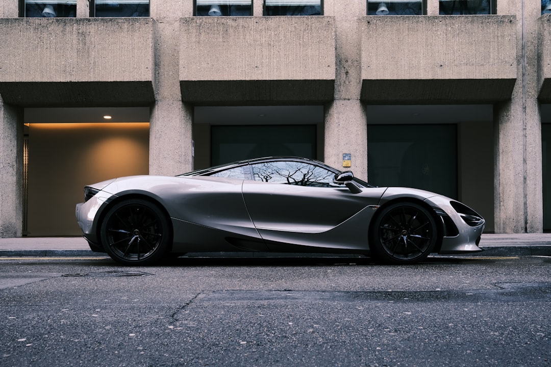 a silver sports car parked in front of a building