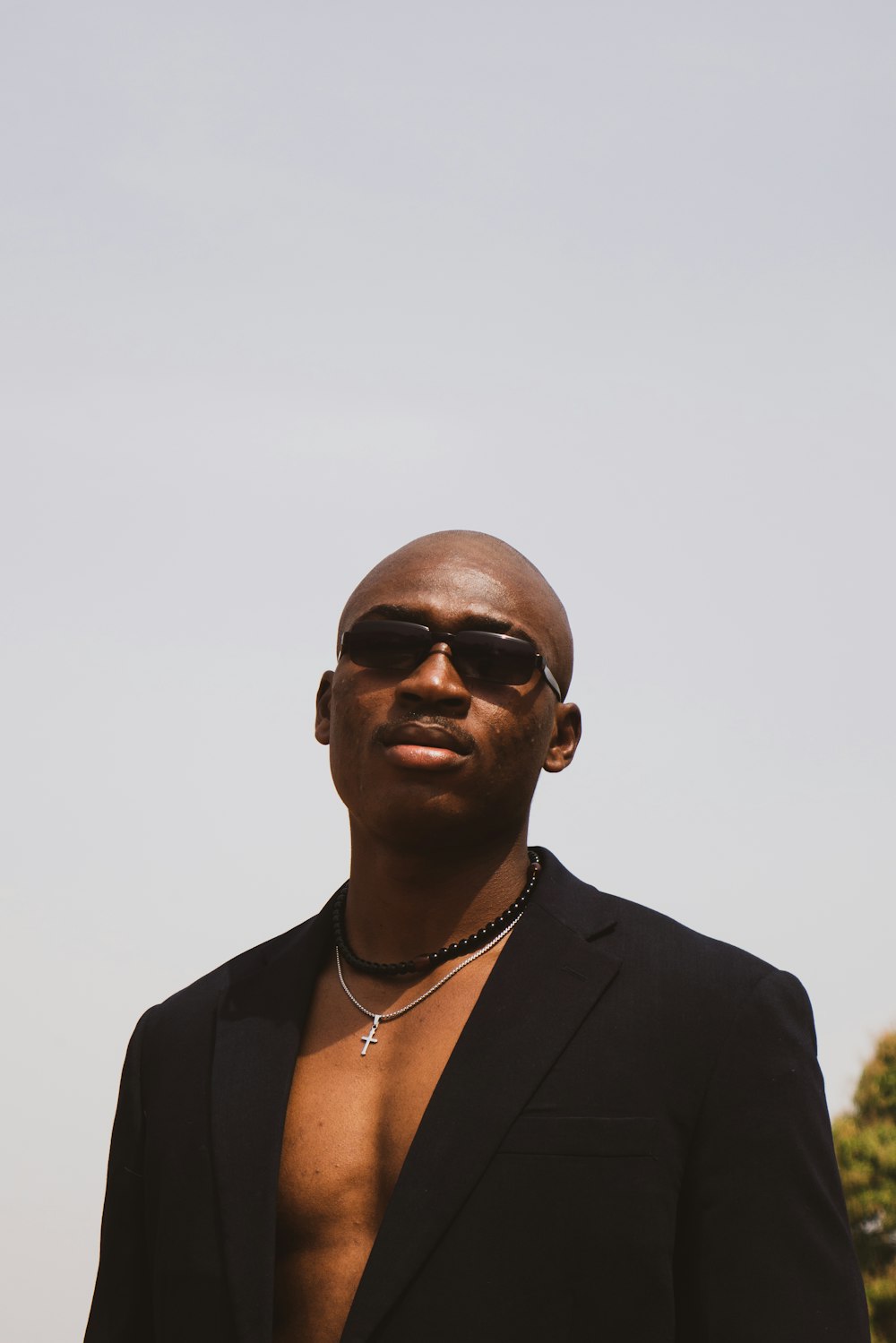 a man in a black suit and sunglasses