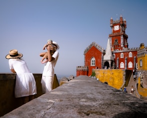 a couple of people that are standing on a wall