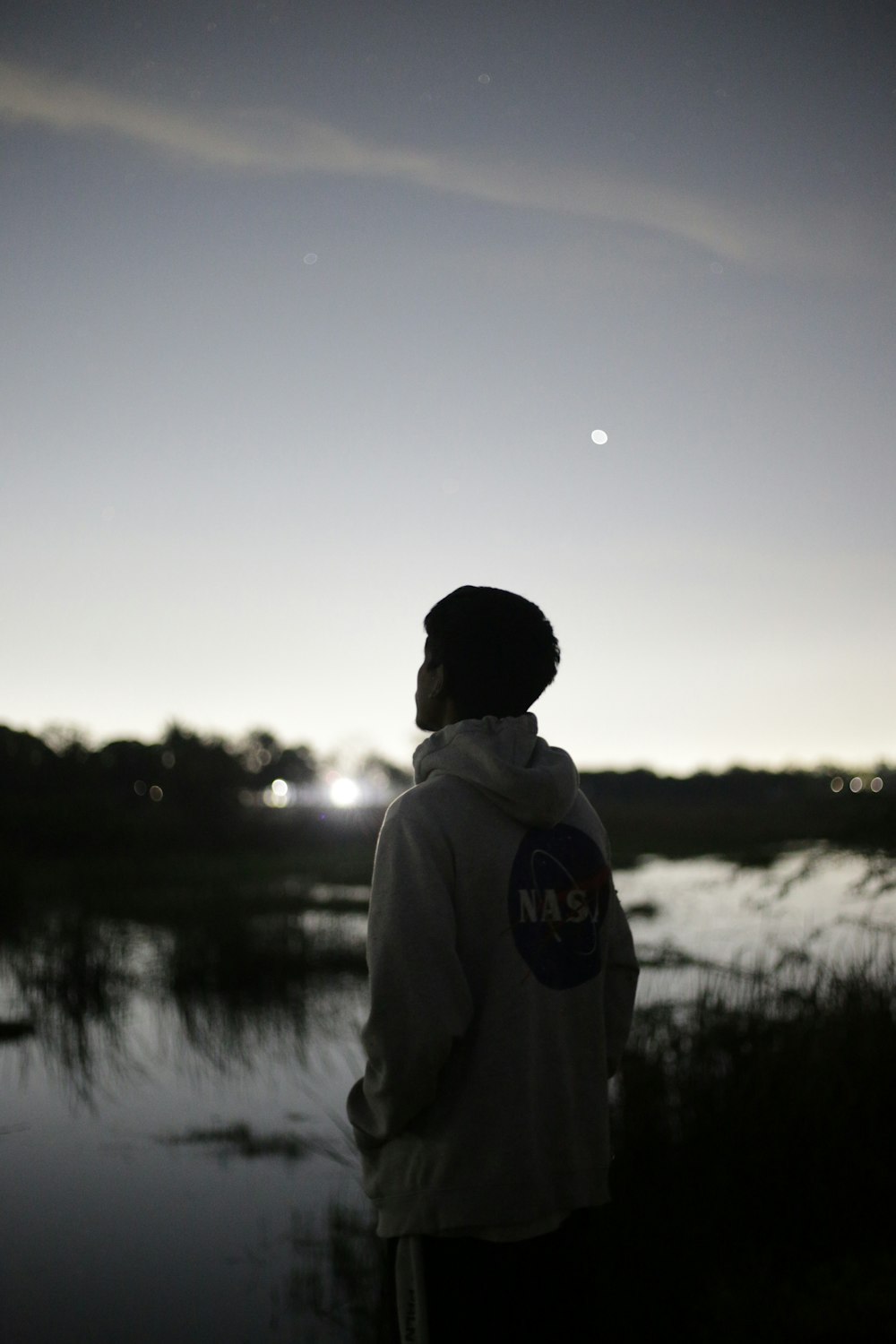 a person standing in front of a body of water