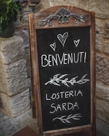 A welcoming entrance of the restaurant with Italian decor and a handwritten menu board.