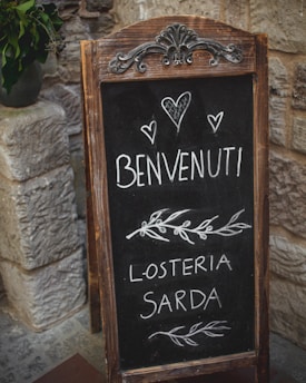 Friendly host welcoming guests at a cozy Sardinian vacation home entrance.