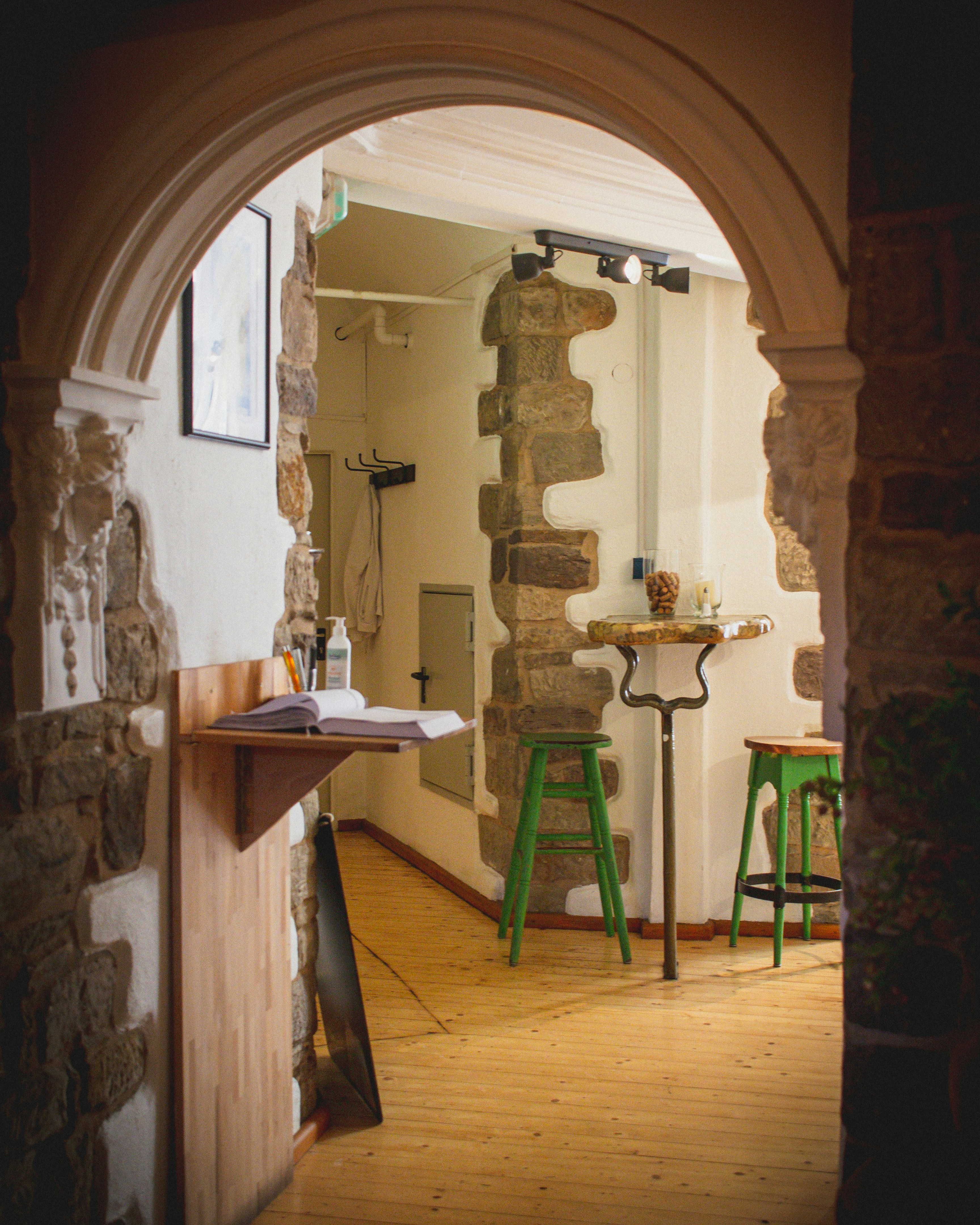 a room with a table and stools in it