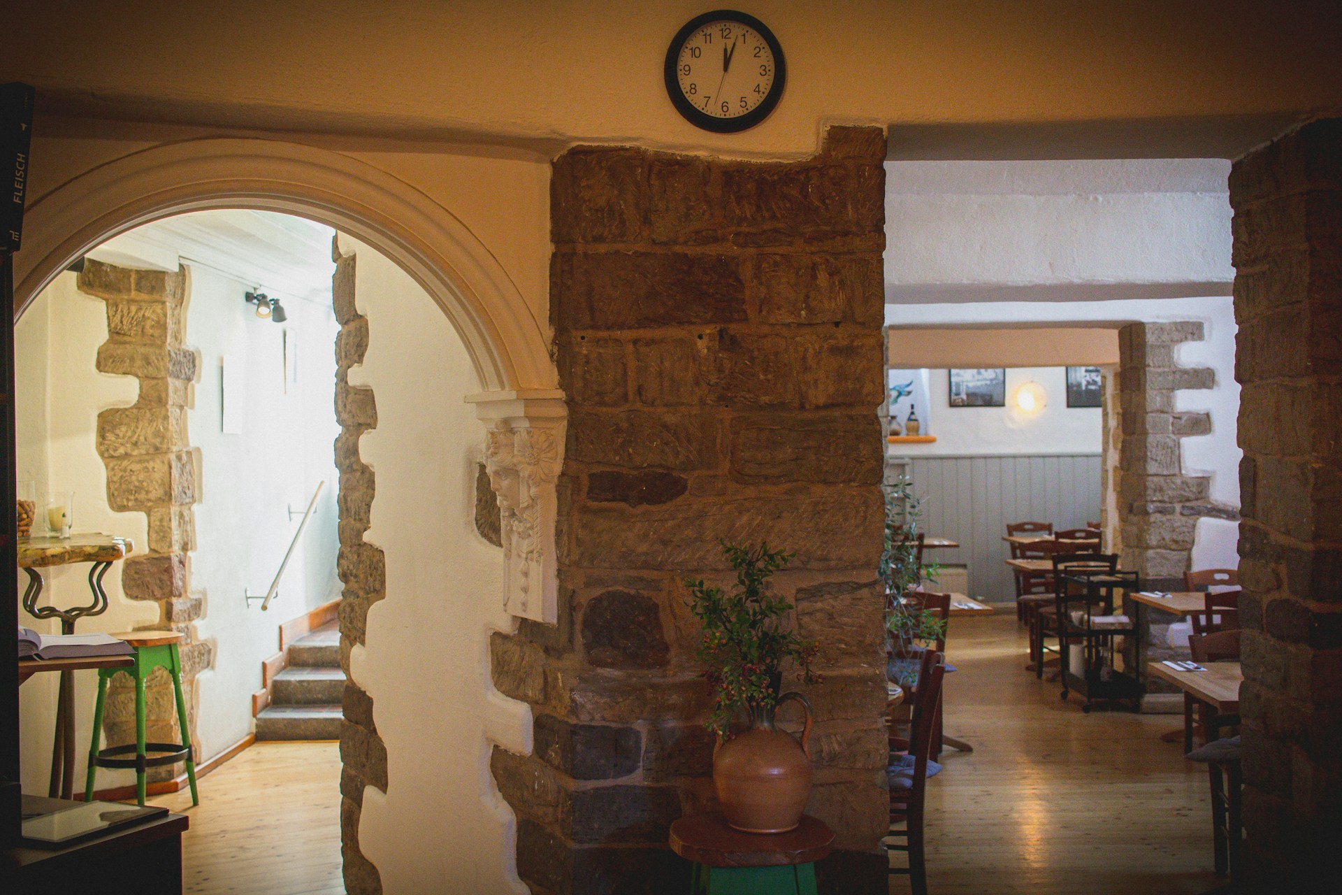 An inviting shot of the cozy interior of Terracotta restaurant, featuring warm terracotta-colored walls and soft lighting over rustic wooden tables.