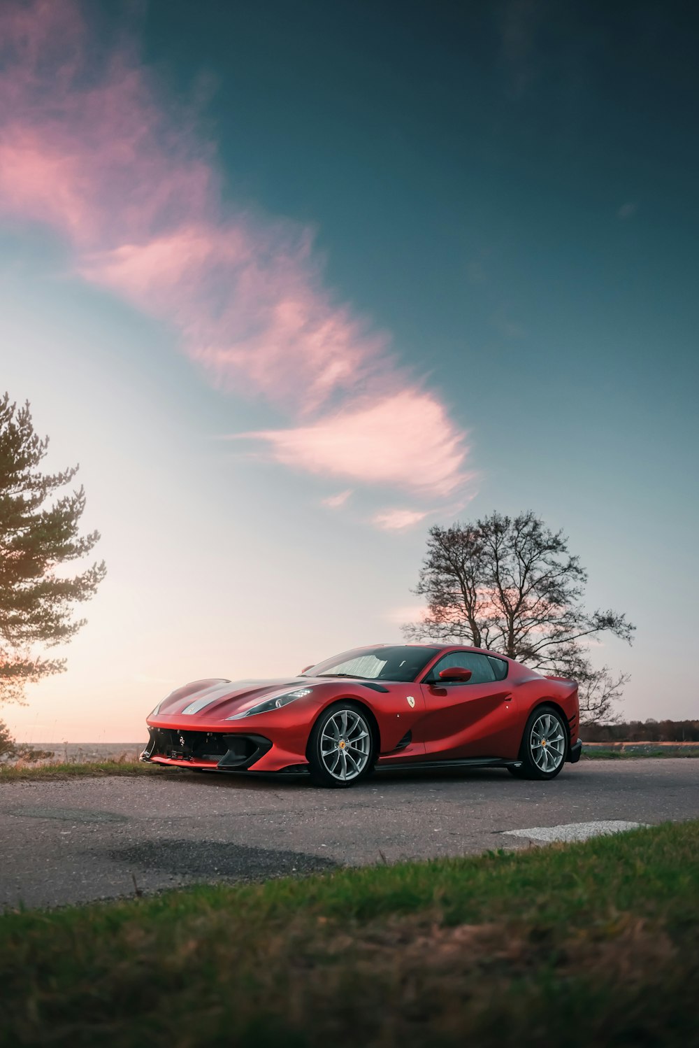 a red sports car parked on the side of the road