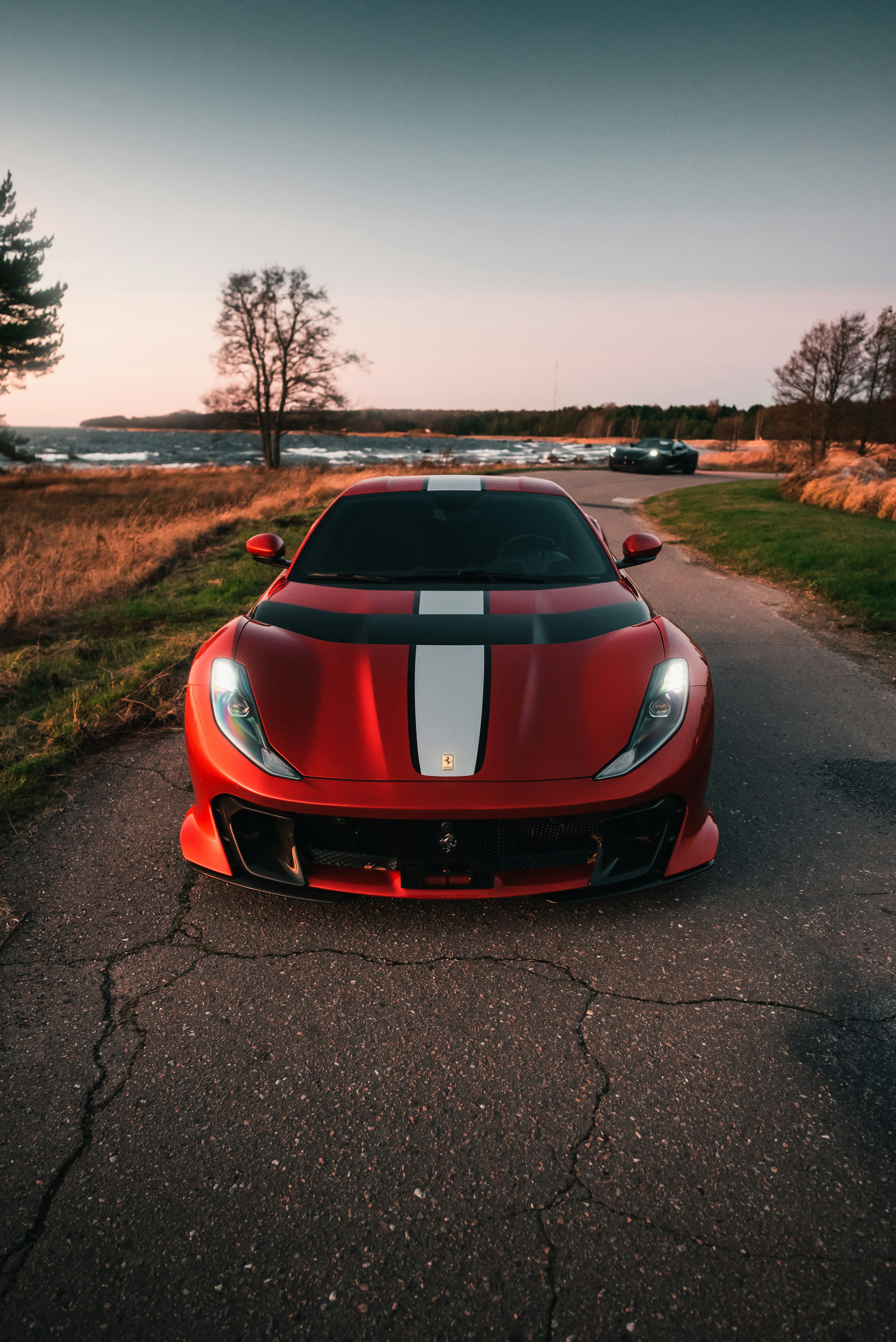 a red sports car parked on the side of a road