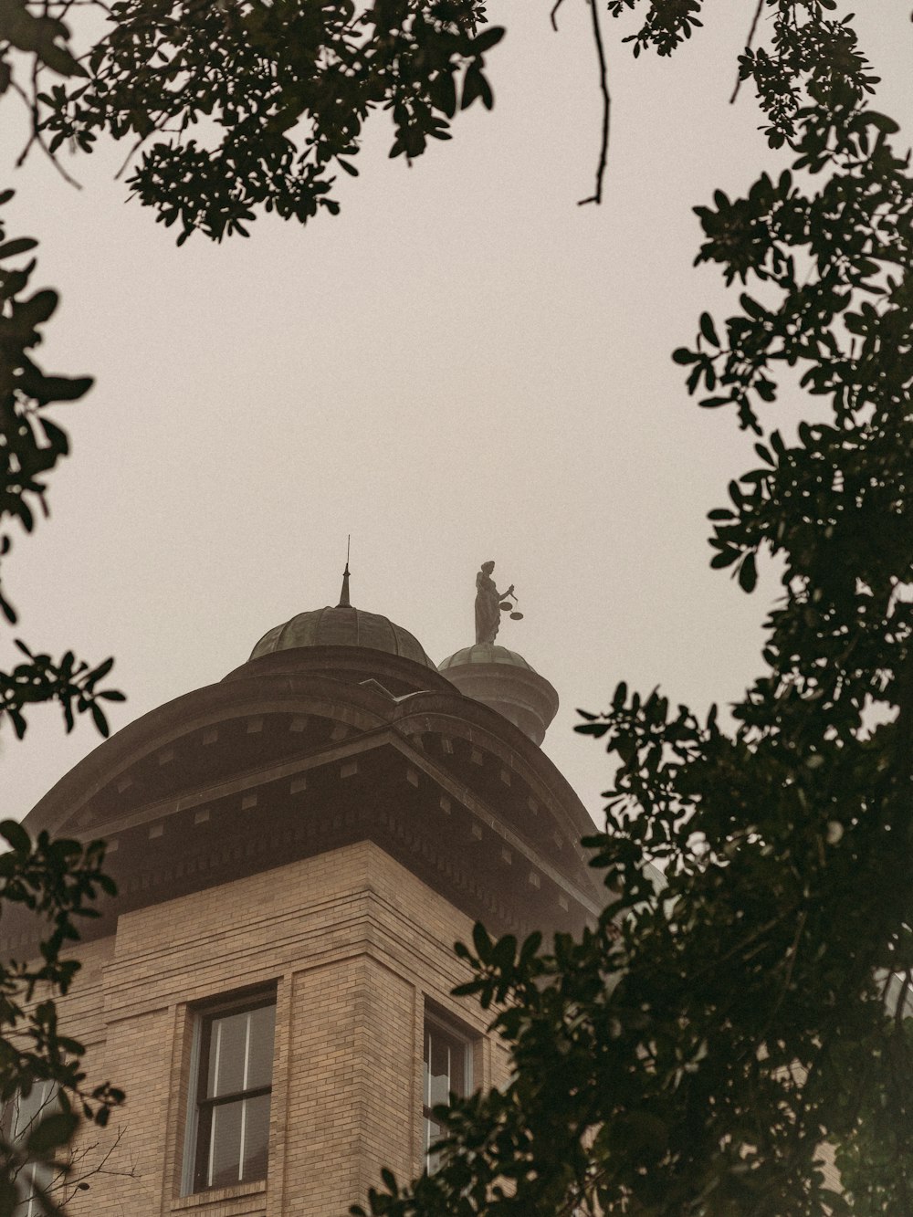 a clock tower with a statue on top of it