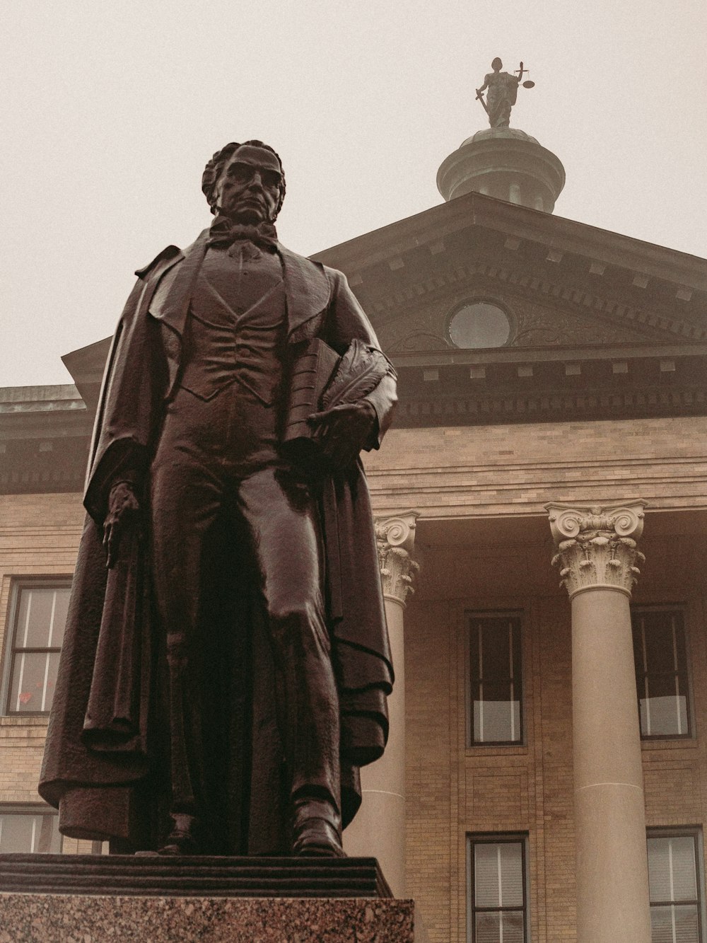 a statue of a man standing in front of a building