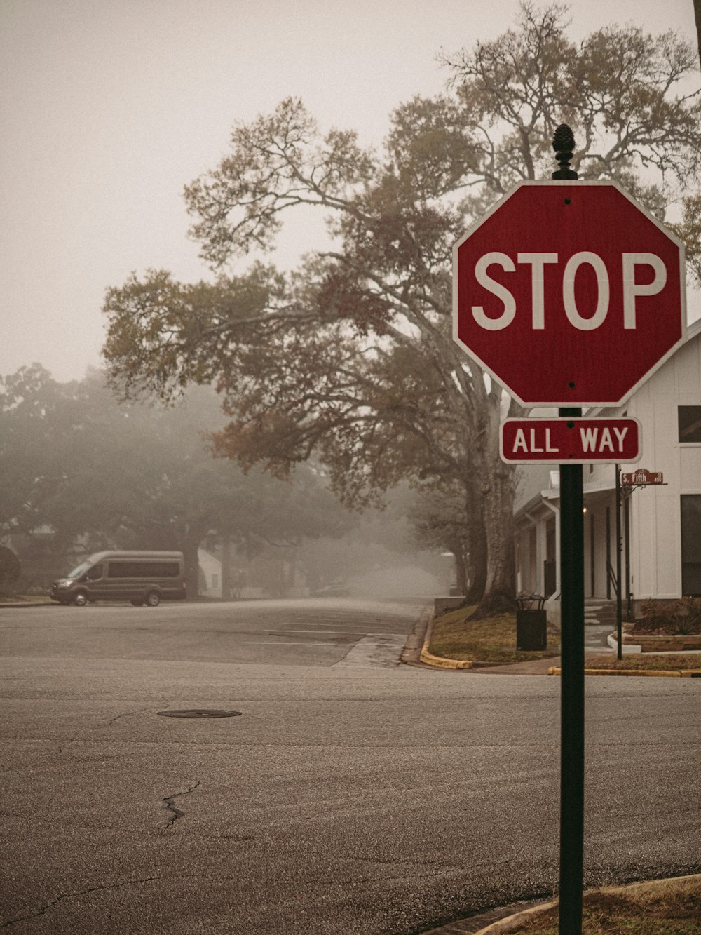 a red stop sign sitting on the side of a road