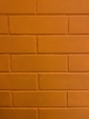 a close up of a brick wall with a clock on it