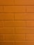 a close up of a brick wall with a clock on it