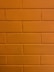 a close up of a brick wall with a clock on it