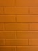 a close up of a brick wall with a clock on it
