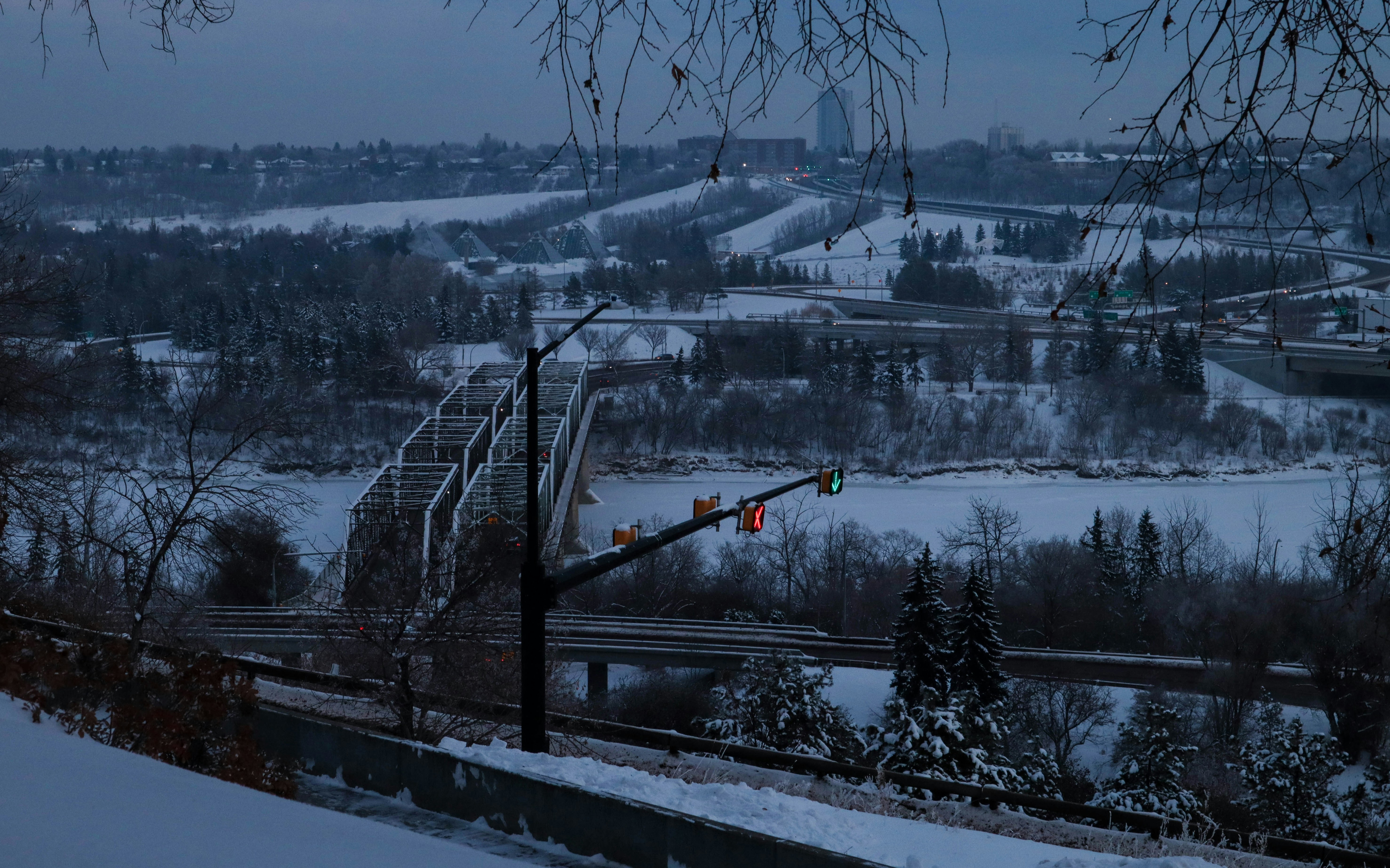 a view of a snowy city from a hill