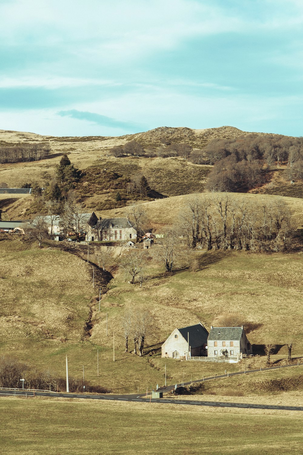 a house on a hill with a farm in the background