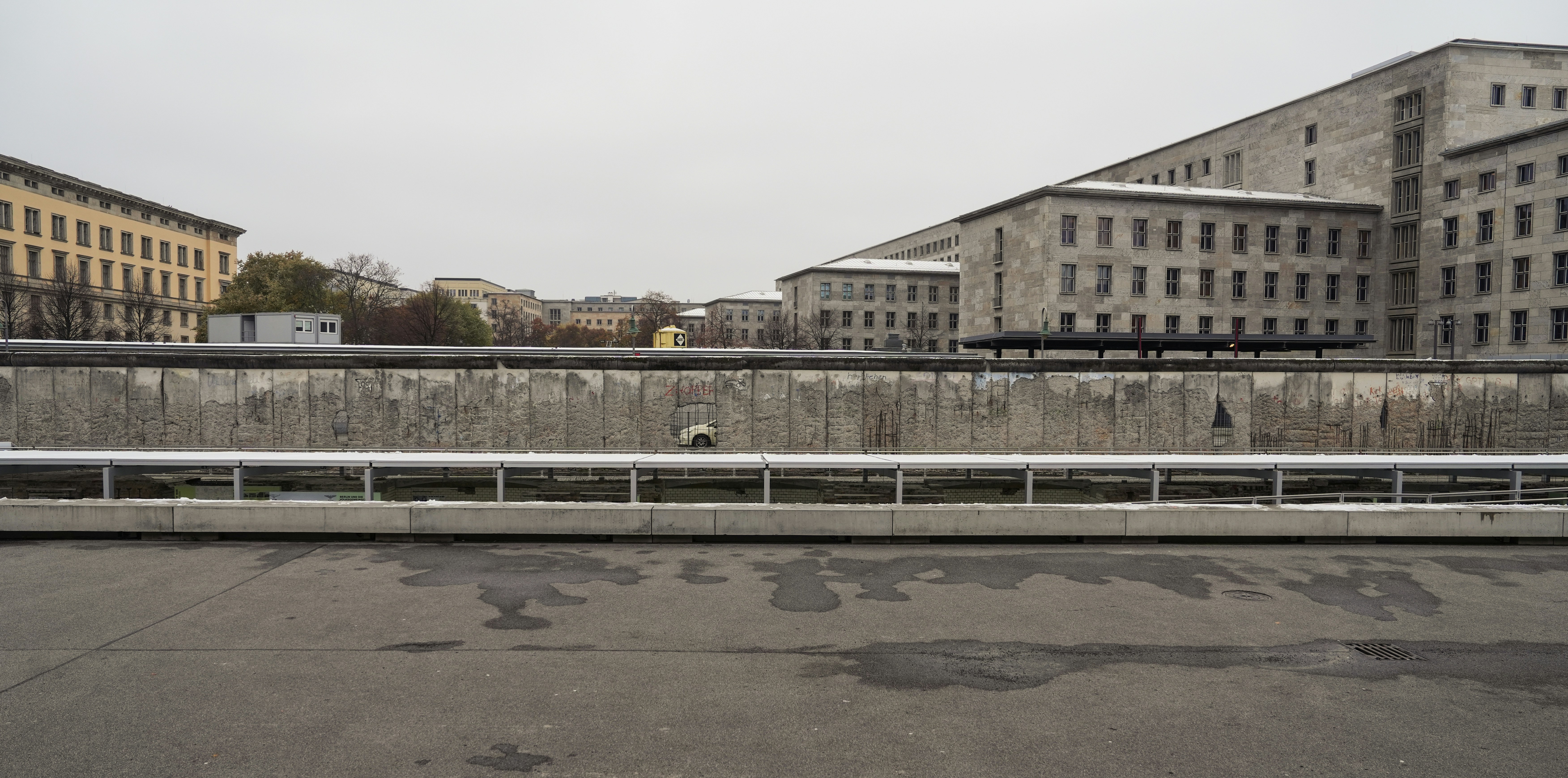 an empty parking lot in front of some buildings, Berlin Wall