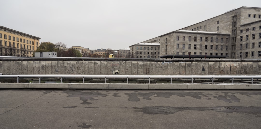 an empty parking lot in front of some buildings, Berlin Wall
