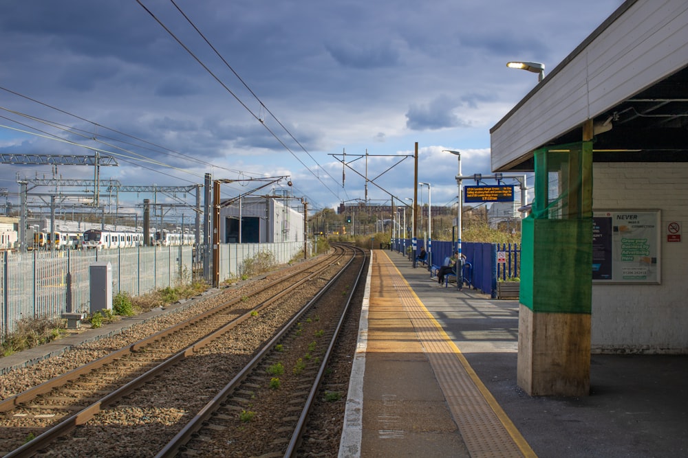 a train station with a train on the tracks