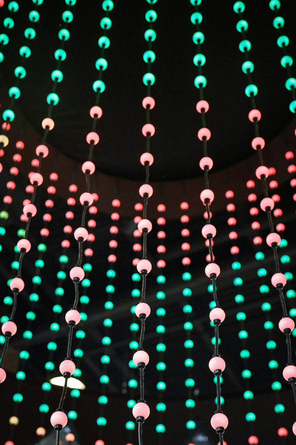 a group of colorful lights hanging from a ceiling
