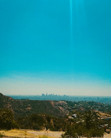 Skyline view from the property showing distant hills under a clear blue sky.