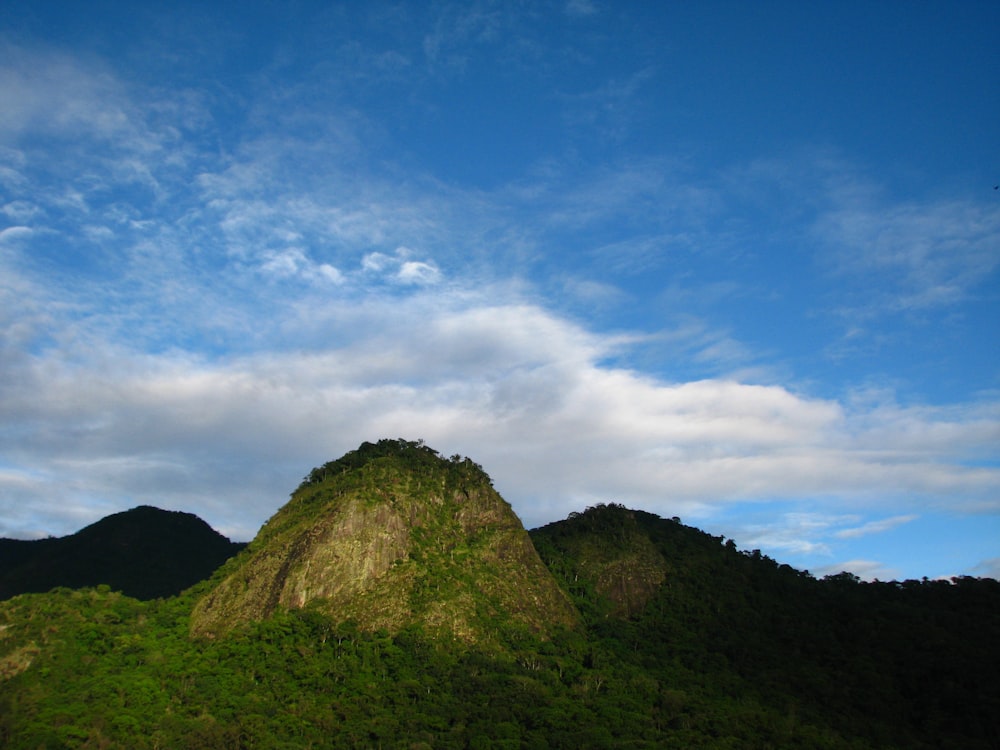 a mountain with a very tall green mountain in the background