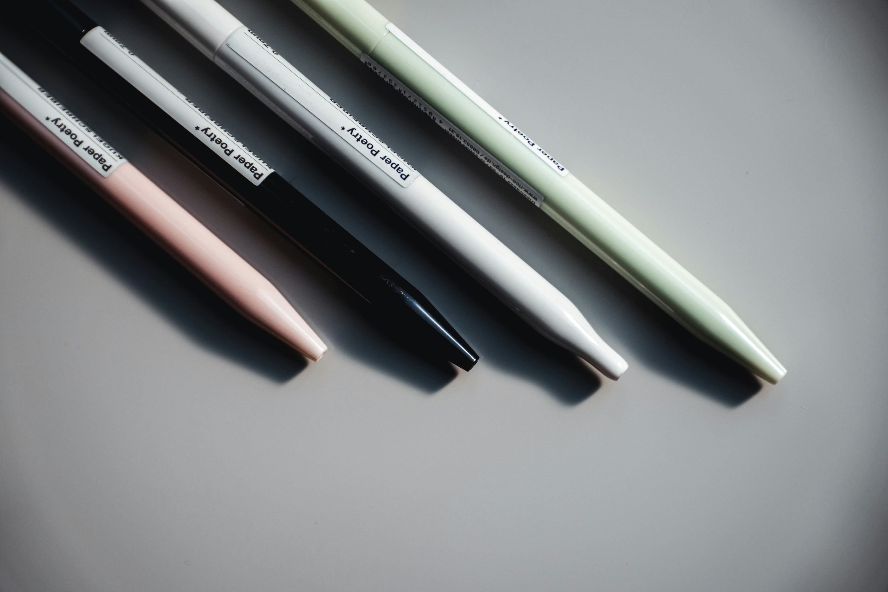 three pens sitting on top of a table next to each other