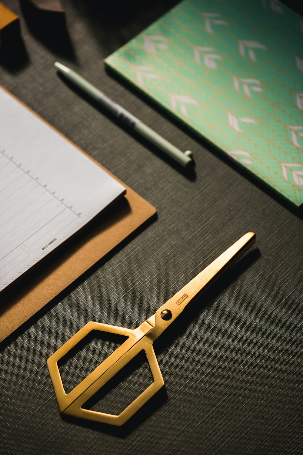 a pair of golden scissors sitting on top of a table