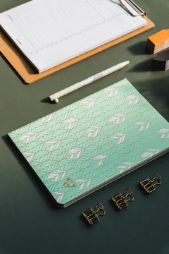 A neatly organized workspace with mint-colored labels and charcoal tape marking zones.