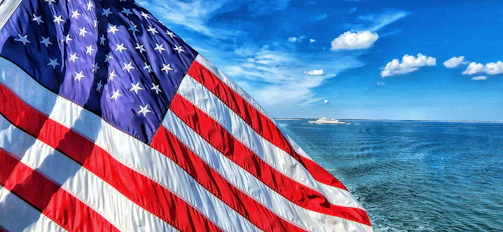 a large american flag on the side of a boat
