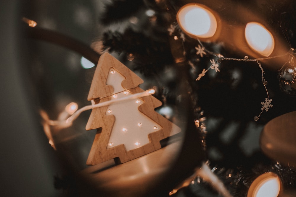 a wooden christmas tree ornament sitting on top of a table