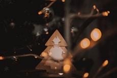 a wooden christmas tree with lights around it