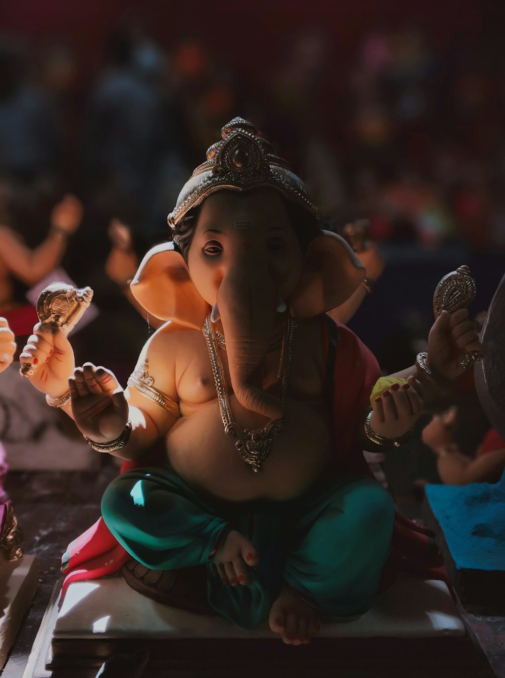 a statue of an elephant sitting on top of a table