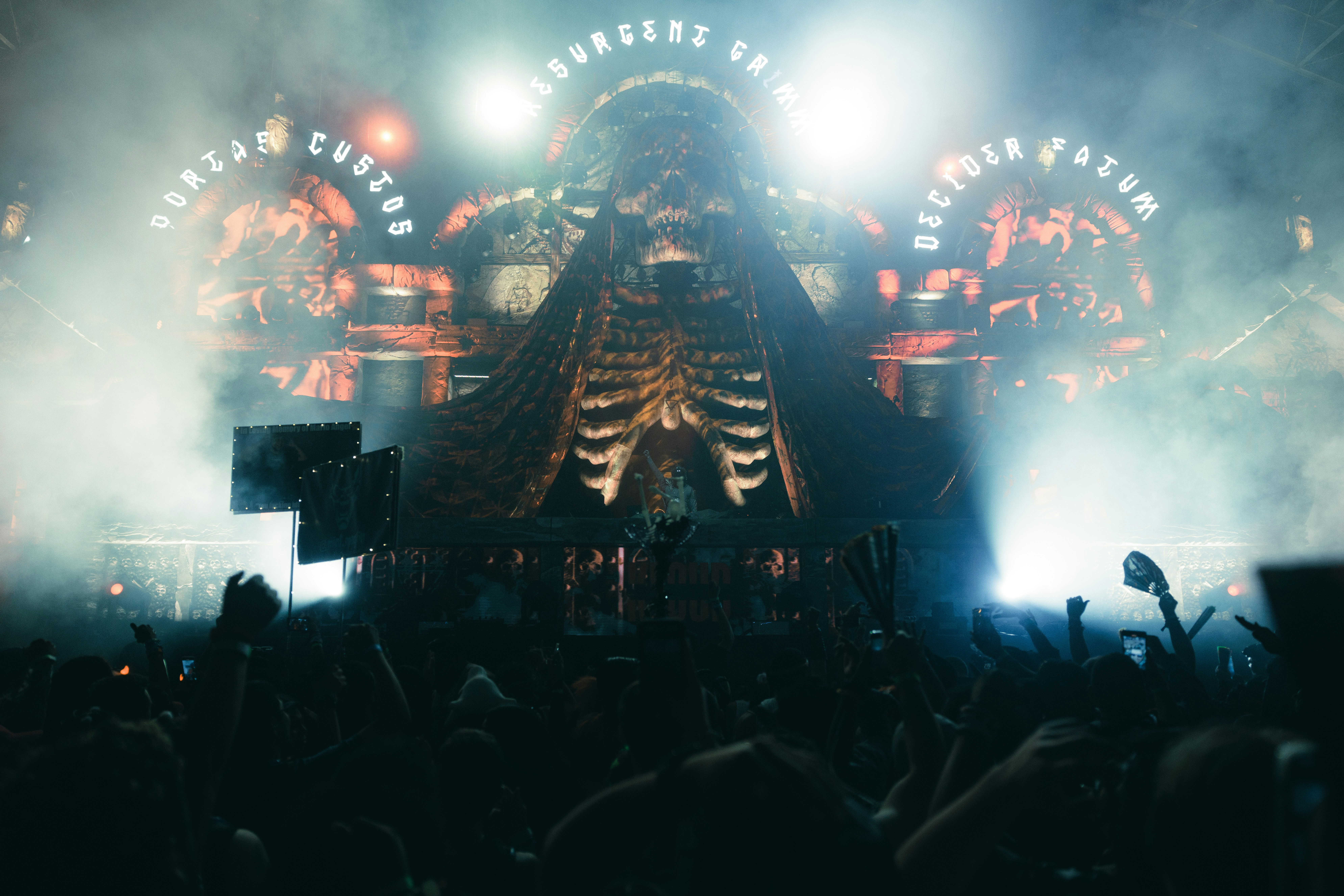 a crowd of people standing around a stage