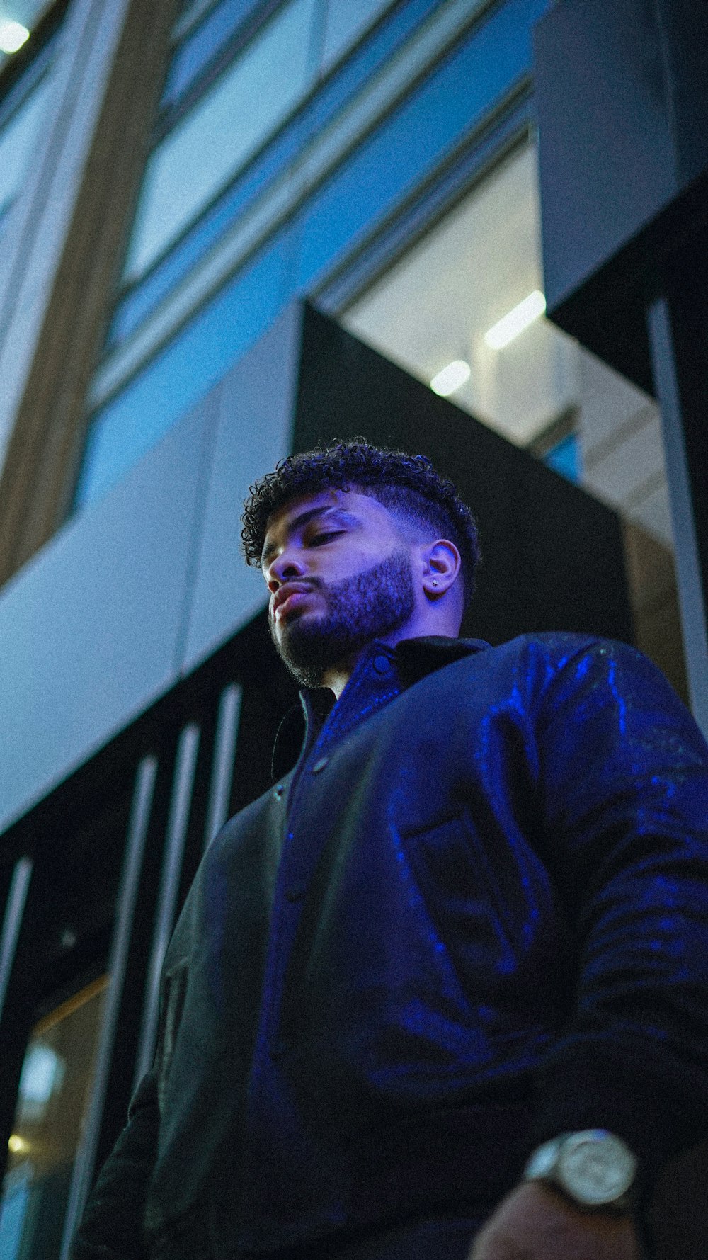 a man standing in front of a tall building