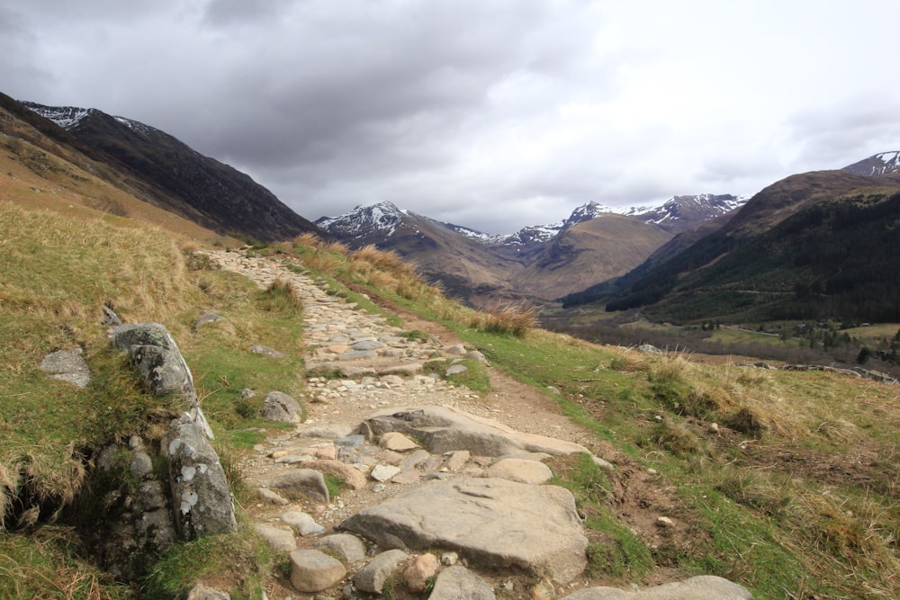 a rocky path in the middle of a valley