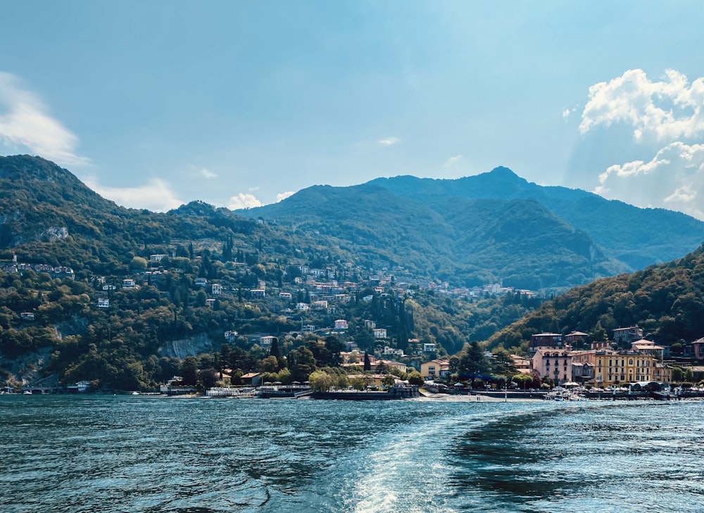 a body of water surrounded by mountains and houses