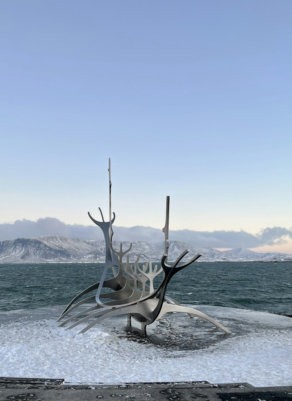 a large metal sculpture sitting on top of a snow covered ground