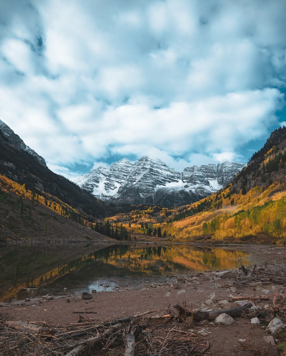 a mountain range with a lake in the foreground