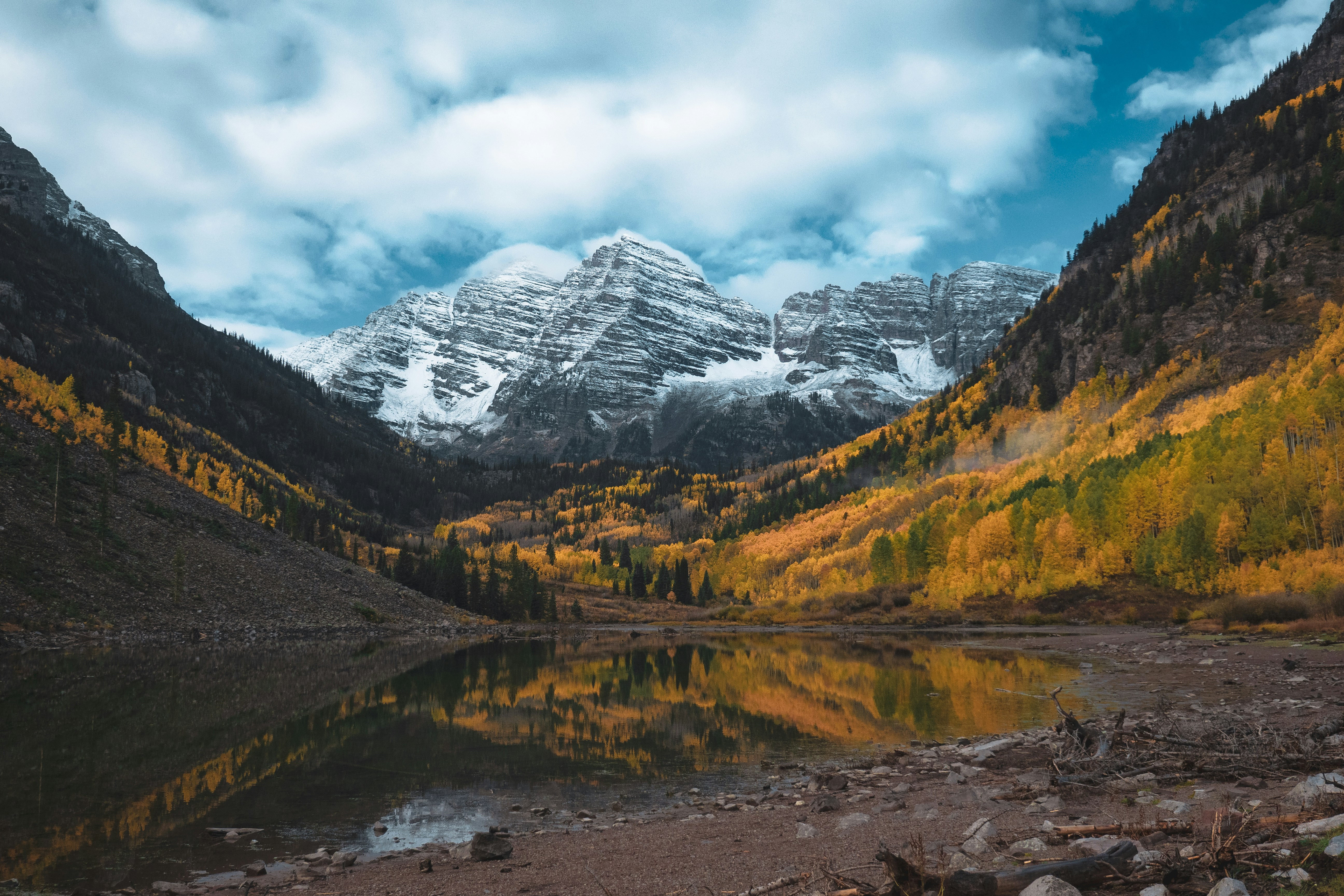 a mountain range with a lake in the foreground, Maroon Bells in Colorado