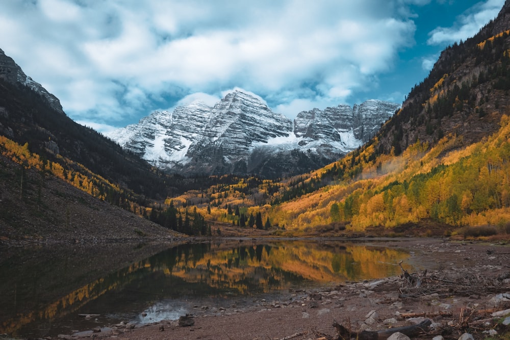 a mountain range with a lake in the foreground