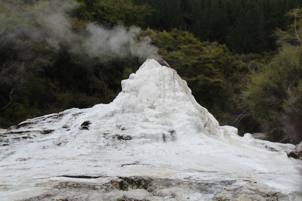 a man standing on top of a snow covered mountain