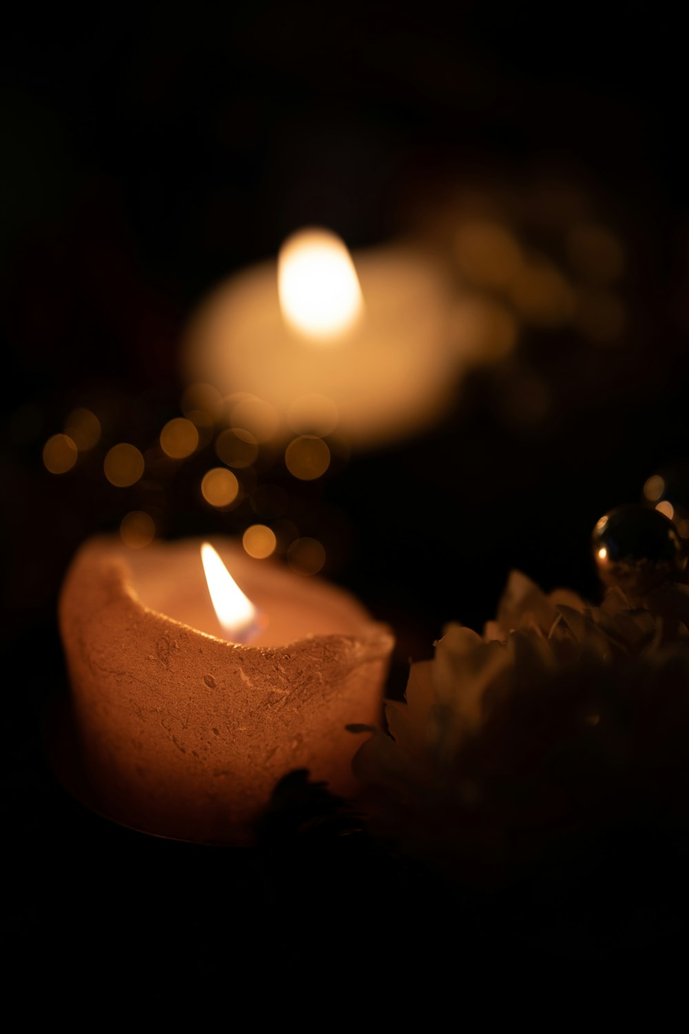 a close up of a lit candle on a table