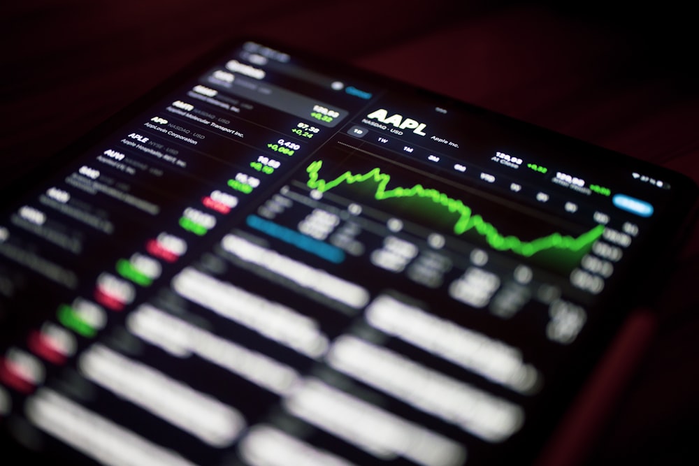 a close up of a cell phone with a stock chart on it