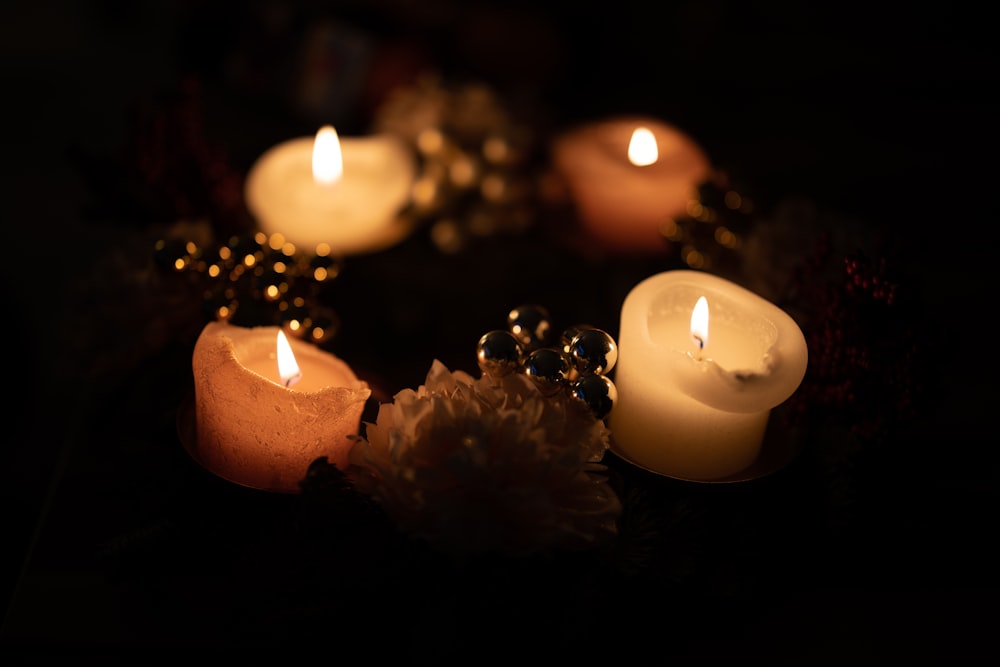 a group of lit candles sitting on top of a table