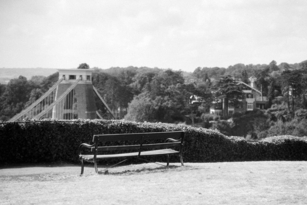 a black and white photo of a park bench