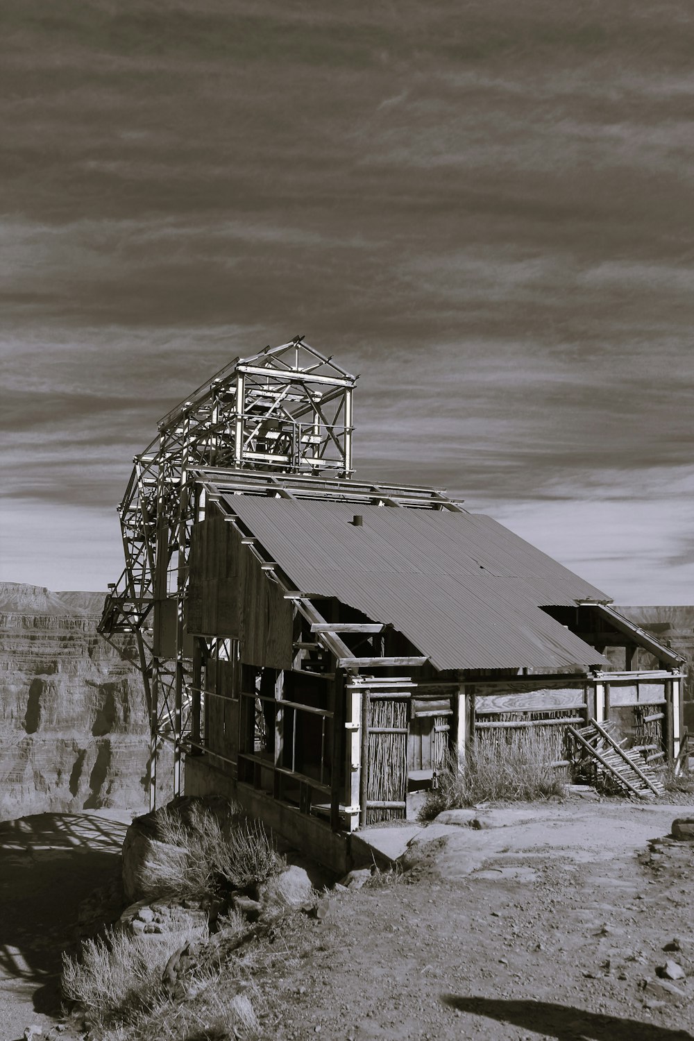 a black and white photo of a building in the desert